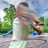 Girl playing with her rainbow hair extension in