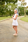 Girl wearing raspberry purple & blue hair extension ponytail kids hair accessories for girls posing with tennis racket