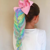 Girl wearing Unicorn hair extensions colorful pink, purple, yellow, blue kids hair accessories for girls French Braid