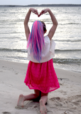 Girls arm heart pose over pink and teal ponytail extension