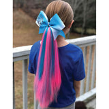 Back view of girl wearing pink and teal  hair extensions 