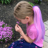 Girl sniffing purple flowers wearing cute pink & purple hair extension