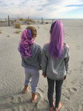 Girls wearing purple & pink hair extensions straight and wavy on the beach