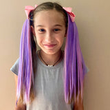 Girl wearing pink & purple ponytail extensions with light pink bow