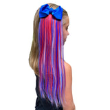 Girl wearing red, white and blue hair extensions with bow