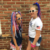 Girls wearing playful red, white & blue hair accessories