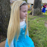 Girl wearing blonde wig playing princess